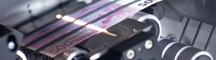 View into the interior of a machine in which a banknote is being x-rayed