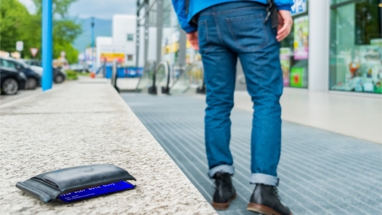 Wallet and card on ground next to man