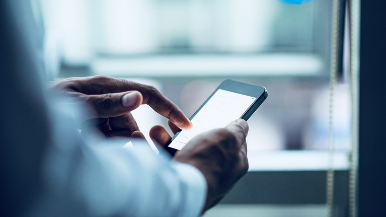 Person holding and using a smartphone