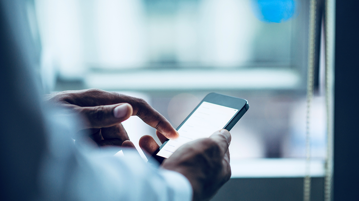 Person holding and using a smartphone